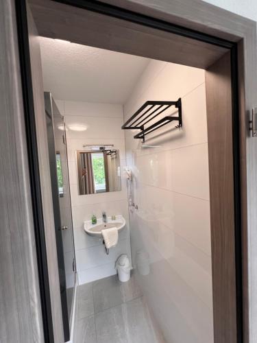 a bathroom with a sink and a toilet at Sleep & Go Motel in Unterbalbach