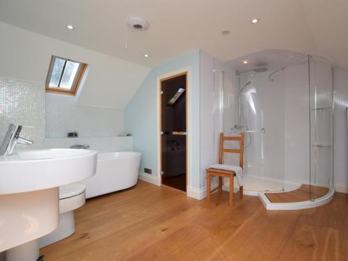 a bathroom with a tub and a sink and a shower at 4 bed property in Moffat 82374 in Moffat