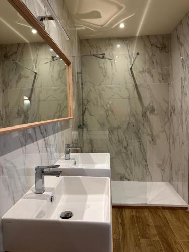 a bathroom with a white sink and a mirror at A un passo dal passo b&b in Pietramala
