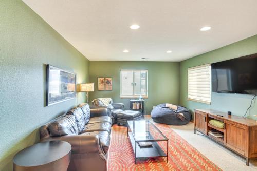 a living room with a leather couch and a flat screen tv at 6 Mi to Skiing Mtn-View Fraser Duplex in Fraser