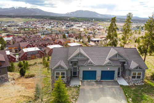 a house with blue garage doors in a residential neighborhood at 6 Mi to Skiing Mtn-View Fraser Duplex in Fraser