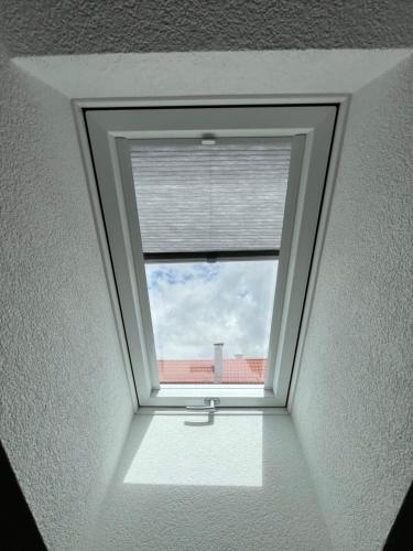 a window in a room with a white ceiling at Sleep & Go Motel in Unterbalbach