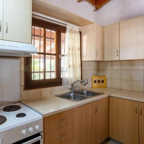 a kitchen with a sink and a stove at Seaside Retreat for Families and Pets in Messini
