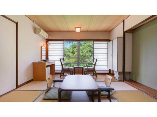 a dining room with a table and chairs in a room at Ibusuki Kaijo Hotel - Vacation STAY 87383v in Ibusuki