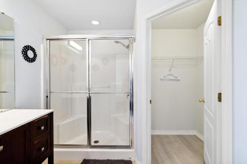 a bathroom with a shower with a glass shower stall at Villa Del Sol in Davenport
