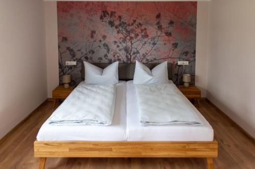 a bedroom with two beds with white sheets at Familienapartment Vogtland in Saalig