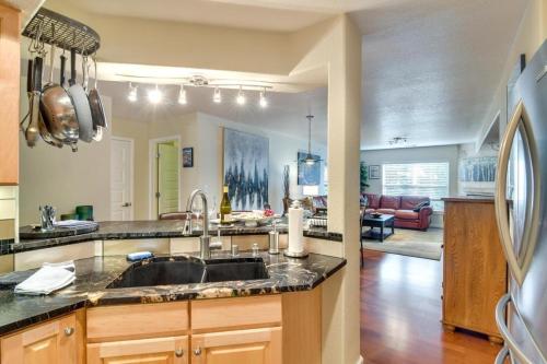 a kitchen with a sink and a living room at River Pines C207 condo in Edwards