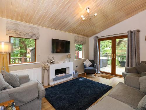 a living room with two couches and a fireplace at Footprints Lodge in Windermere