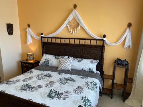 a bedroom with a large bed with a canopy at Corona del Mar By Rocky Host in Puerto Peñasco