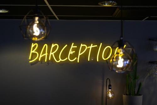 a neon sign that says barbershop hanging from the ceiling at Comfort Hotel Jönköping in Jönköping