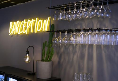 a neon barhibition sign in a room with glasses at Comfort Hotel Jönköping in Jönköping