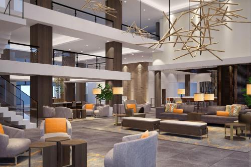 a lobby with couches and chairs in a building at Delta Hotels by Marriott Ontario Airport in Ontario
