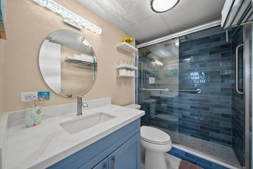 a bathroom with a sink and a toilet and a mirror at Waikiki Ocean Fantasy, Free Parking, Beach Supplies in Honolulu