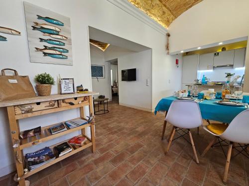 a kitchen with a blue table and chairs in a room at Casa Limoncello, tipica, cosy, localização top, Olhão in Olhão
