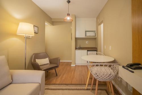 a living room with a couch and a table at The Capital Flat Itaim Bibi in Sao Paulo