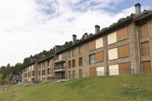 a large brick building on top of a hill at El Ciervo de Santa María by BeValle in Panticosa