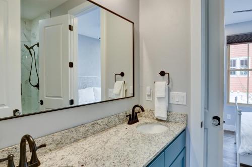 a bathroom with a sink and a large mirror at South Main Residences by Surf Hotel in Buena Vista