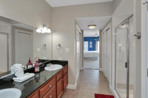 a bathroom with two sinks and a walk in shower at Paradise Shores 310 by Pristine Properties Vacation Rentals in Mexico Beach