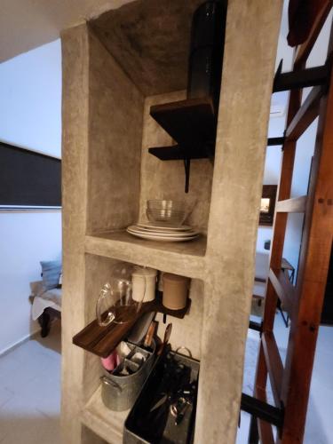 a kitchen with a staircase with a table and plates at Campo Paraíso Suites in Mérida