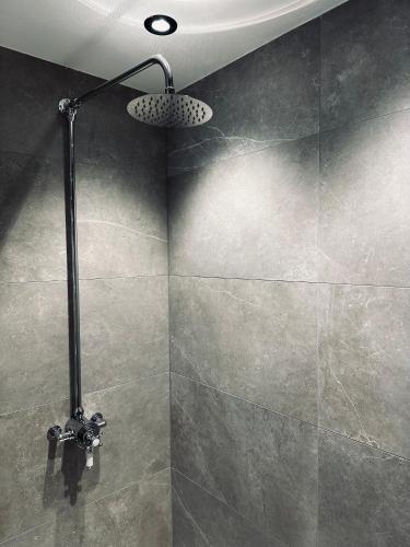 a shower with a shower head in a bathroom at South Causey Inn in Stanley