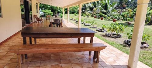 a wooden table and bench on a patio at Fare NATIHERE Huahine 2 in Haapu