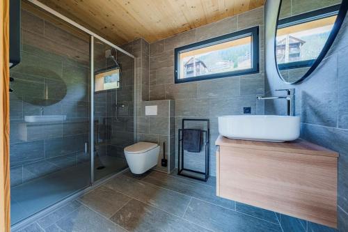 a bathroom with a tub and a sink and a shower at Chalet Alpea - 8 personnes in Châtel