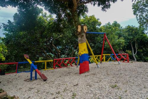 a playground with a monkey on a swing at Finca el Triunfo in Melgar