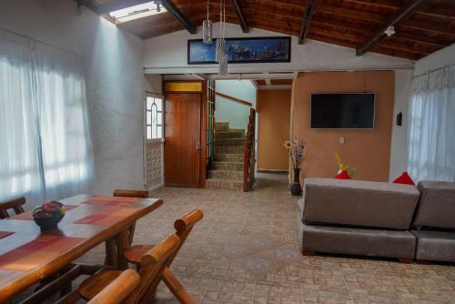 a living room with a table and a couch at Finca el Triunfo in Melgar