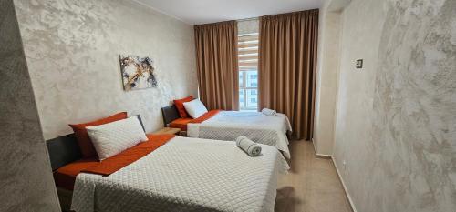 a hotel room with two beds and a window at Luxury apartment near TGV station and the beach in Tangier