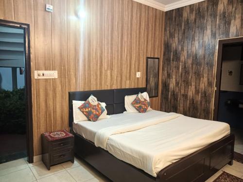 a bedroom with a bed with white sheets and pillows at Shikha Resort Ewentbliz in Bhīm Tāl
