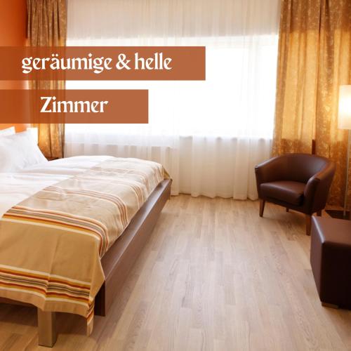 a bedroom with a bed and a chair at Hotel Lava Inn - 24 h Check-In - Nähe LKH, Landeskrankenhaus, Feldbach in Feldbach