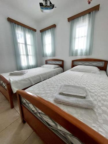 a bedroom with two beds with towels on them at Amorgos Aegean Heaven in Amorgos