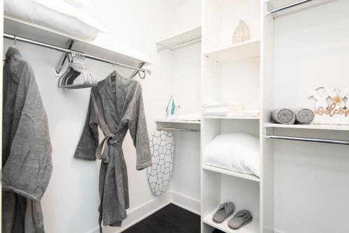 a walk in closet with white walls and shelves at Sky-Rise Apartments in Los Angeles