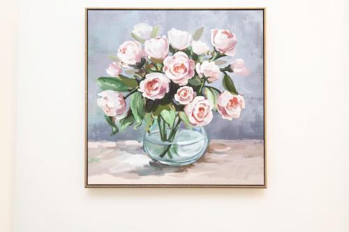 a painting of pink roses in a vase at Sky-Rise Apartments in Los Angeles