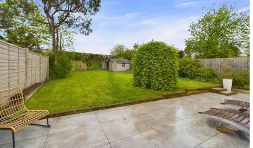 a backyard with a fence and a grass yard at relaxed and peaceful in St. Ives