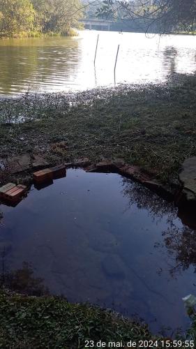 a large puddle of water on the side of a river at Cabana de pesca e lazer Represa Usina Mafra sc in Mafra