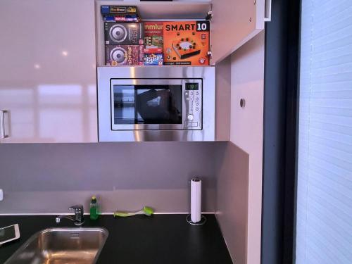 a kitchen with a sink and a microwave at Haus in Ribnitz Damgarten for 3 Personen in Ribnitz-Damgarten