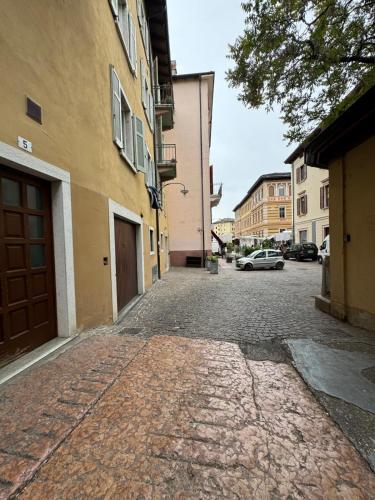 a cobblestone street with a building and a car on it at Duomo Nest entire apartment in Trento