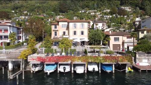 a group of boats are docked in a marina at Arbostora Charme Hotel in Morcote