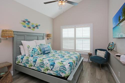 a bedroom with a bed and a blue chair at Second Chance by Pristine Properties Vacation Rentals in Mexico Beach