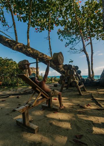a man sitting in a chair on a playground at Natura Cabana Boutique Hotel & SPA by Mint in Cabarete