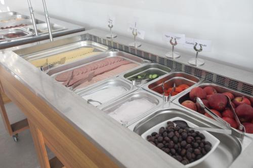 a kitchen sink filled with lots of fruits and vegetables at Pavlinia Hotel & Apartments in Ayia Napa