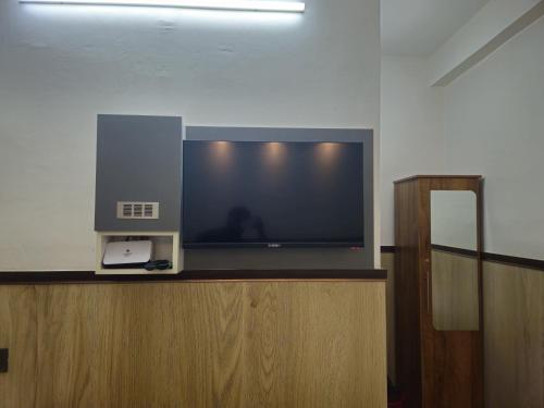 a flat screen tv sitting on top of a counter at Noor Plaza in Angamali