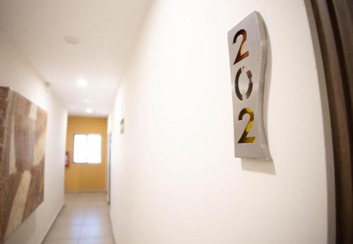 a hallway with a clock on the wall at Hotel Villa Express Durango in Durango