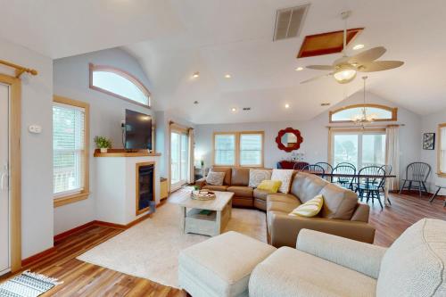 a living room with a couch and a table at House of the Rising Sun #5-W in Waves