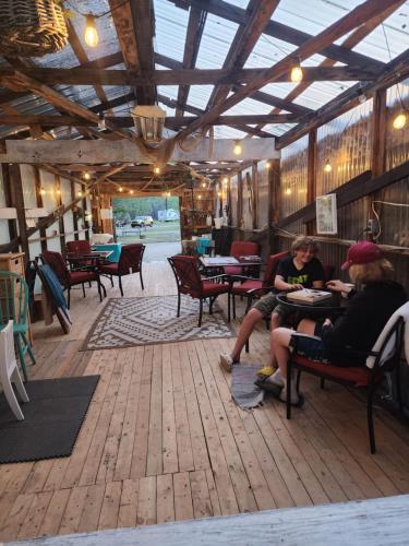 a group of people sitting at tables in a restaurant at D1 StarGazer Geo Dome- 1 Queen- No pets in Drumheller