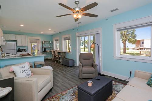 a living room with blue walls and a ceiling fan at Beach View Lower by Pristine Properties Vacation Rentals in Mexico Beach