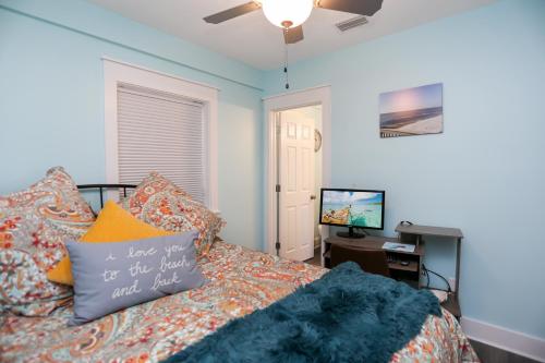a bedroom with a bed and a desk and a television at Beach View Lower by Pristine Properties Vacation Rentals in Mexico Beach