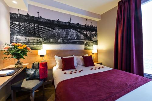 a hotel room with a bed and a desk and a bridge at Midnight Hôtel Paris in Paris
