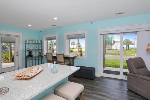 a living room with a table and chairs at Beach View Lower by Pristine Properties Vacation Rentals in Mexico Beach